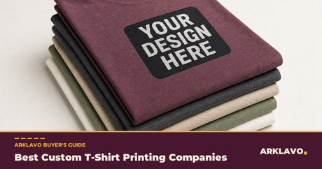 Best custom t-shirt printing companies buyer's guide: a stack of folded custom t-shirts with a Your Design Here print on the top shirt