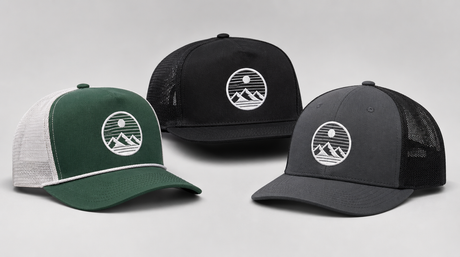 Three custom embroidered trucker hats arranged for product photography: green and white retro trucker with mesh back, black five-panel trucker, and charcoal modern trucker, all with simple custom embroidered logos
