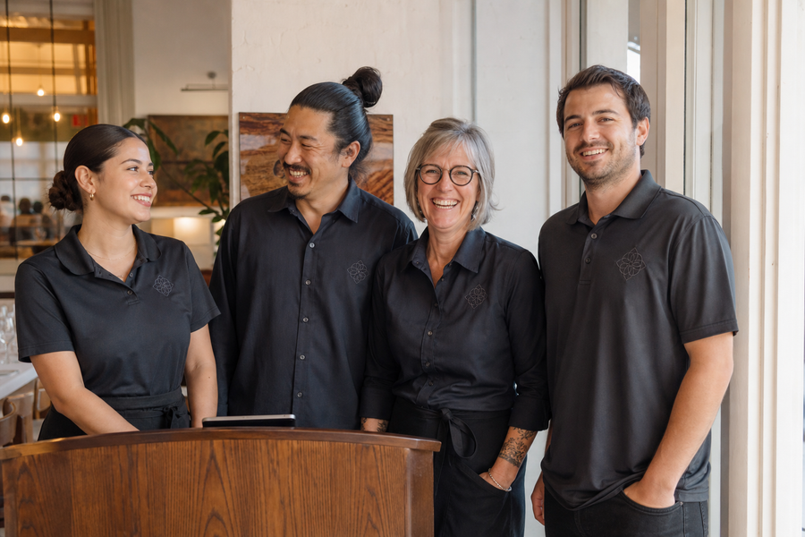 A restaurant team in matching custom embroidered shirts