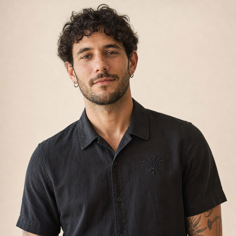 A man wearing a custom embroidered polo showing the fit