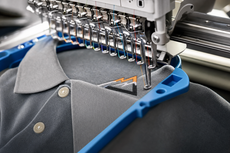 Embroidery machine stitching a logo onto a polo