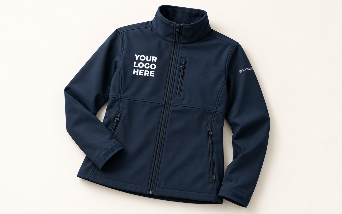 Navy softshell jacket with white YOUR LOGO HERE on the right chest, clear of the center and chest-pocket zips.