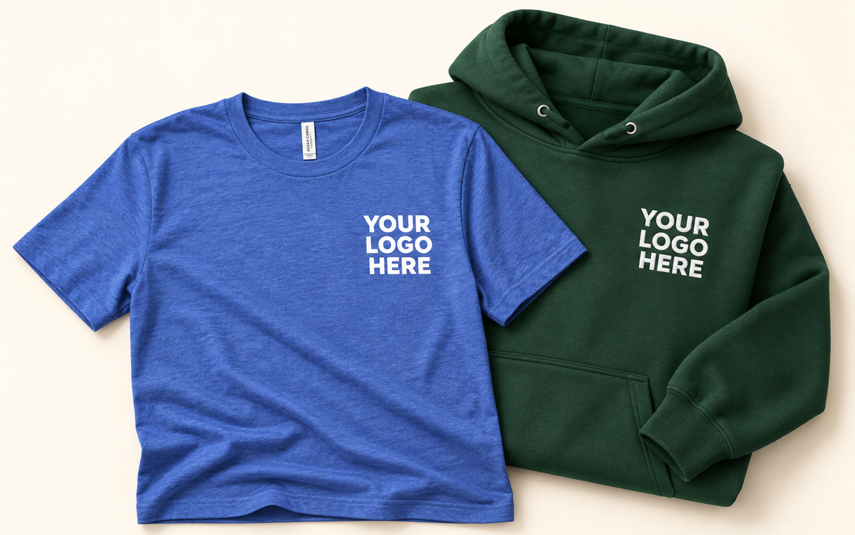 Blue T-shirt and green pullover hoodie with white YOUR LOGO HERE on the left chest.