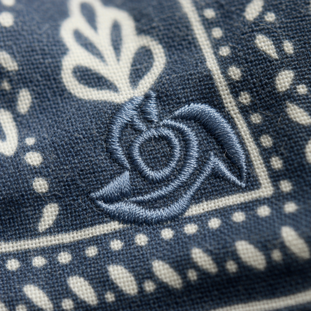 Close-up of an embroidered logo on a bandana