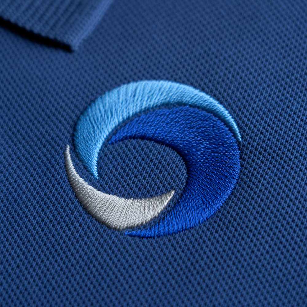 Close-up of an embroidered logo on a corporate polo