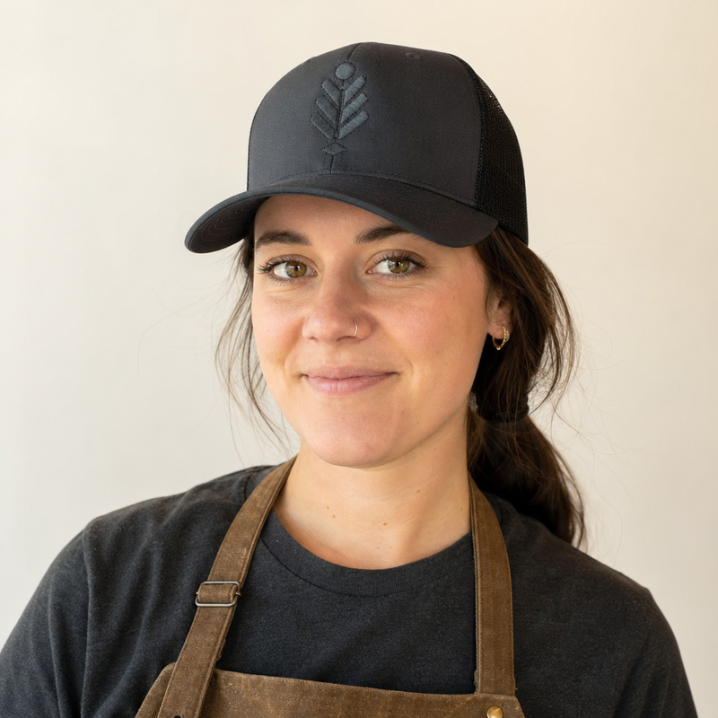 A woman wearing a custom embroidered cap showing the fit