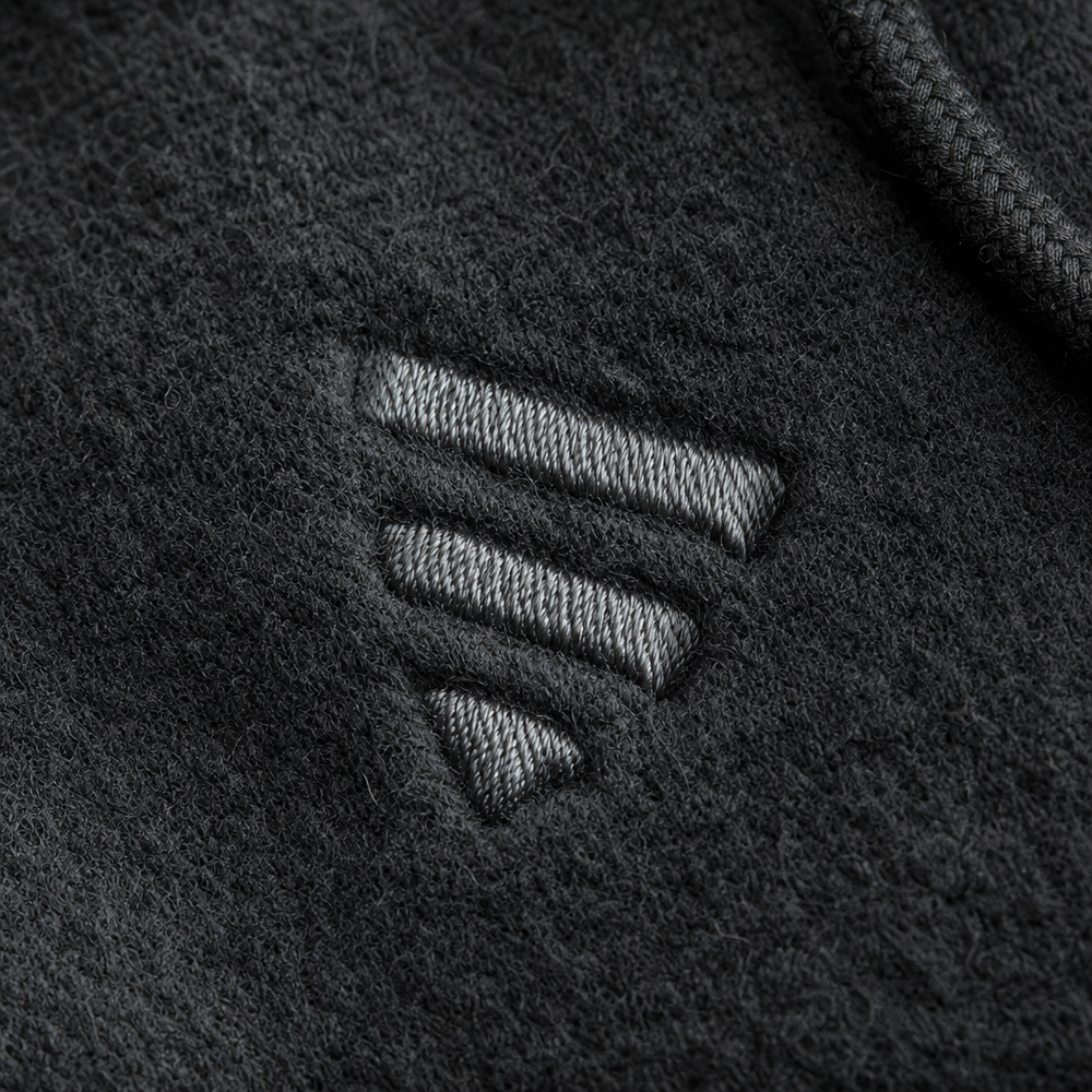 Close-up of an embroidered logo stitched into a custom hoodie