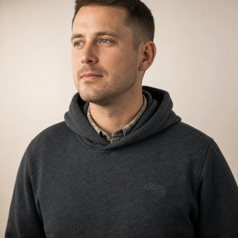 A man wearing a custom pullover hoodie over a shirt collar, showing the everyday fit
