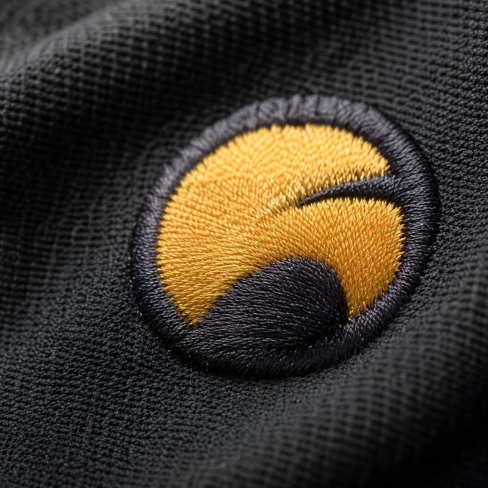 Close-up of an embroidered logo on a restaurant uniform