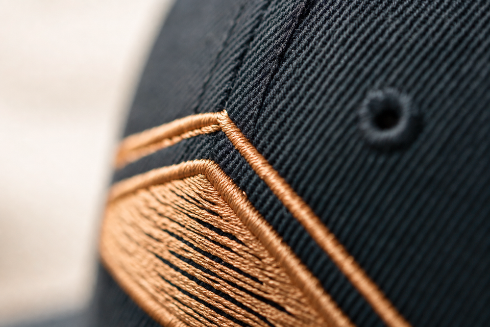 Close-up of embroidery detail on custom snapback hats
