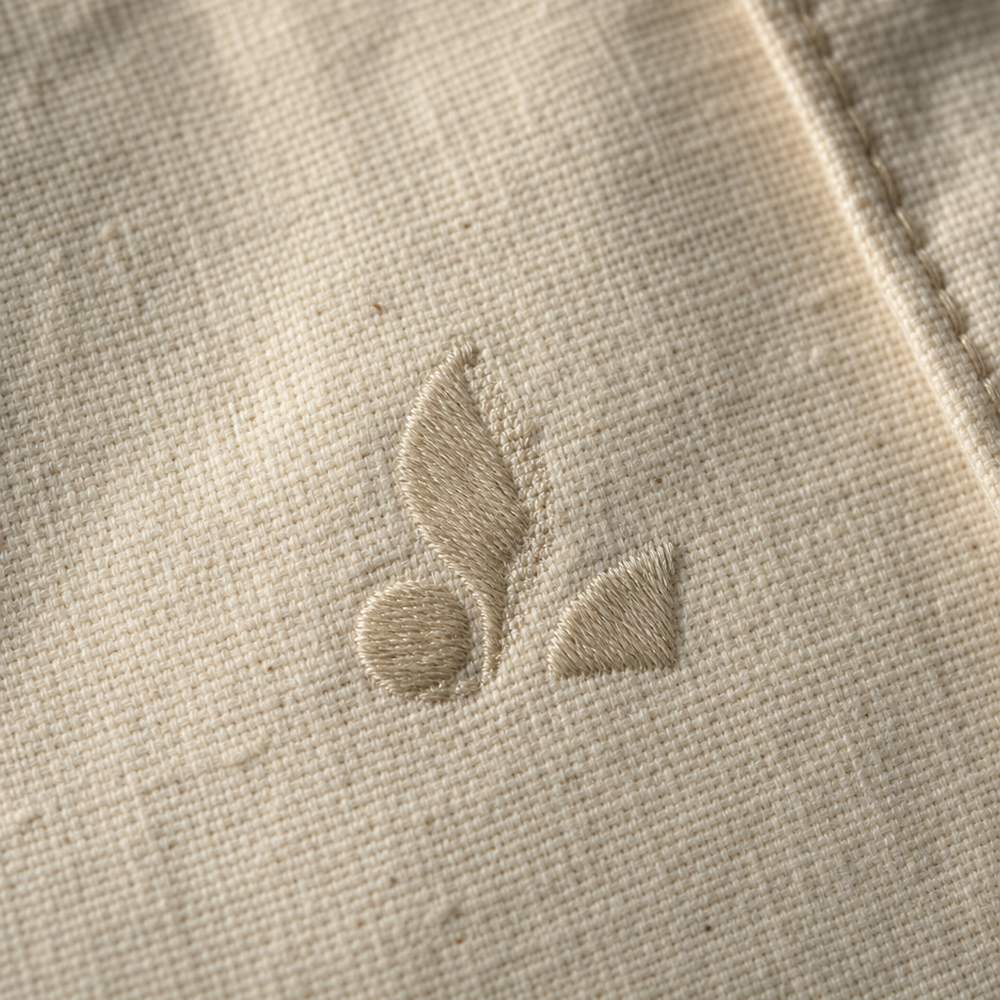 Close-up of an embroidered logo on a tote bag