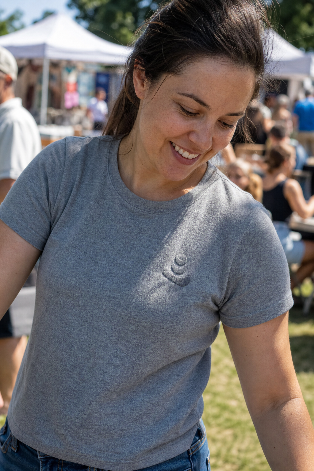 A small-business owner wearing a custom embroidered t-shirt