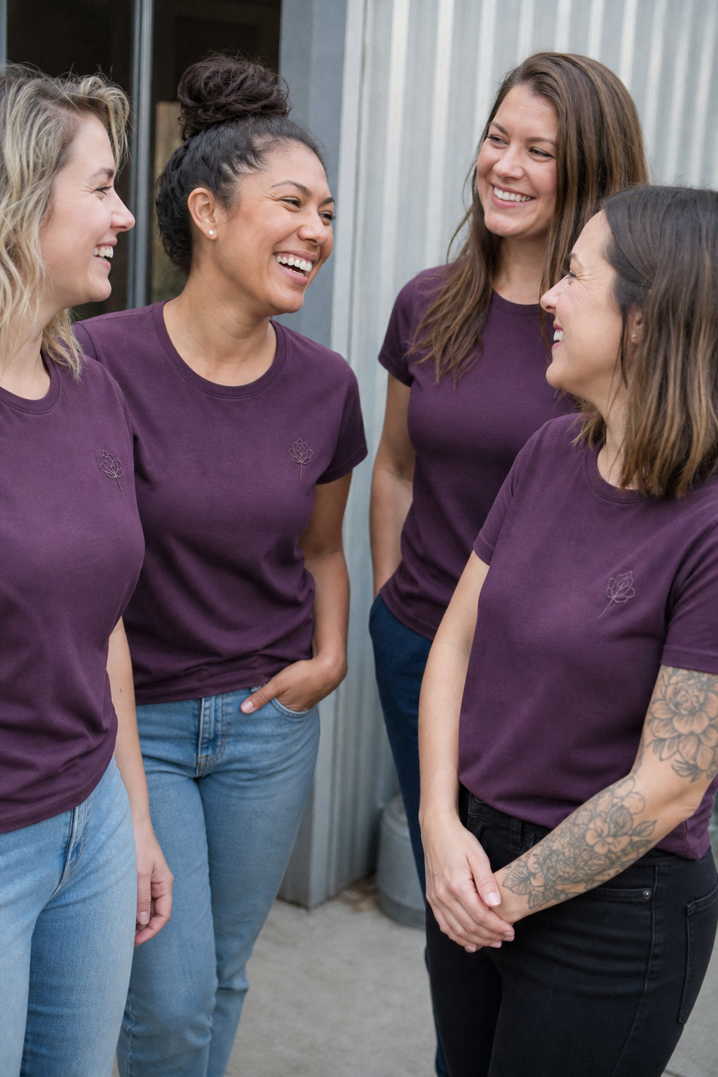 Women coworkers in matching custom t-shirts with an embroidered emblem